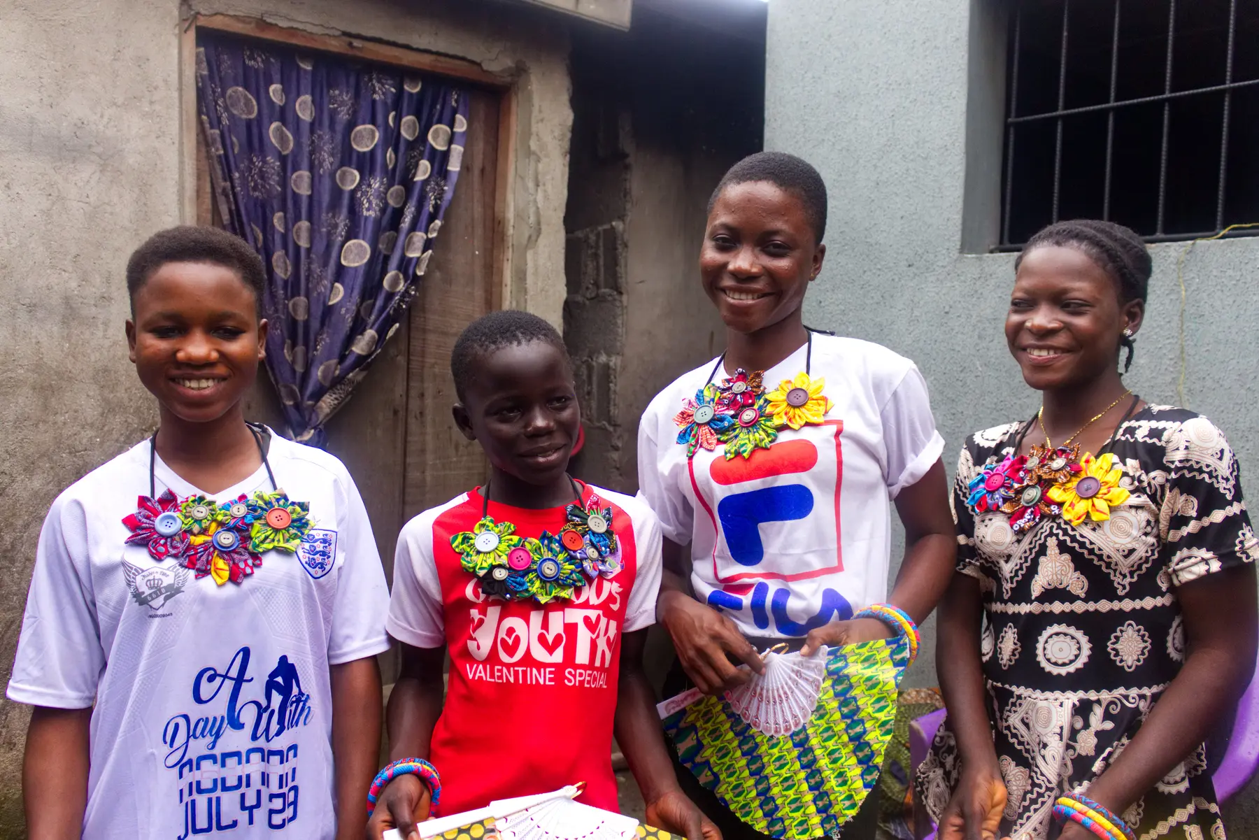 Young people showing handmade jewellery